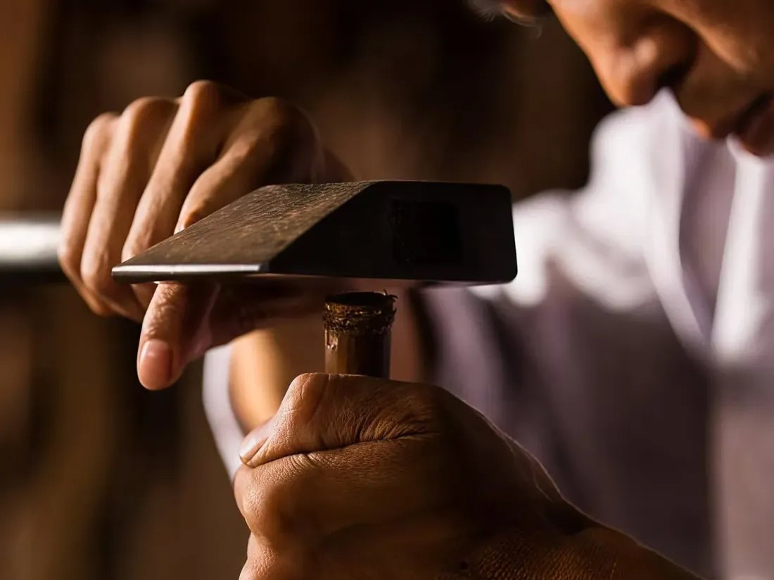 An artisan hand-carving a piece